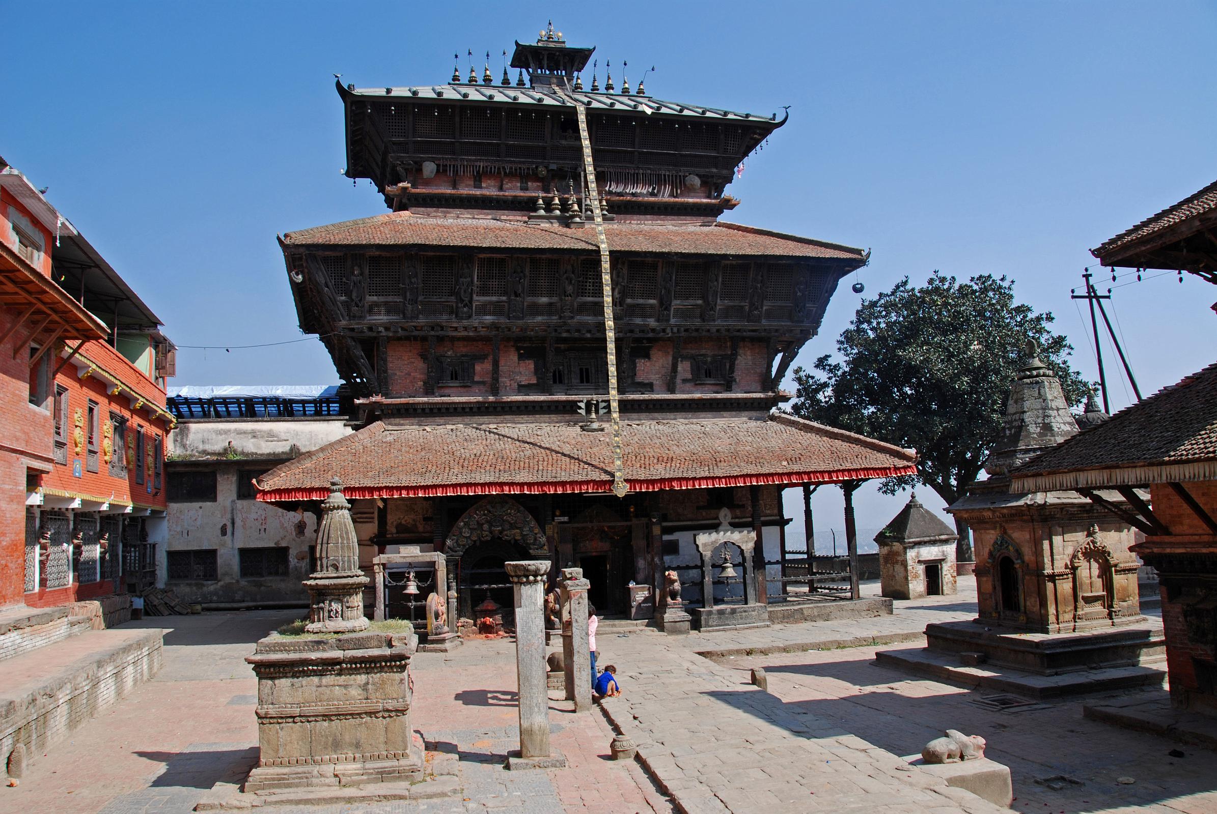 Kathmandu 09-2 Kirtipur Bagh Bhairav Temple Full View On the saddle between the two Kirtipur hills south of Kathmandu is the three-storied Bagh Bhairav Temple, built between 1099 and 1126. The temple is dedicated to Shiva the Destroyer (Bhairav) in the form of a tiger (bahg). The temple is covered with swords and shields that belong to the troop of Kirtipur, who were defeat by the army of King Prithvi Narayan Shah.